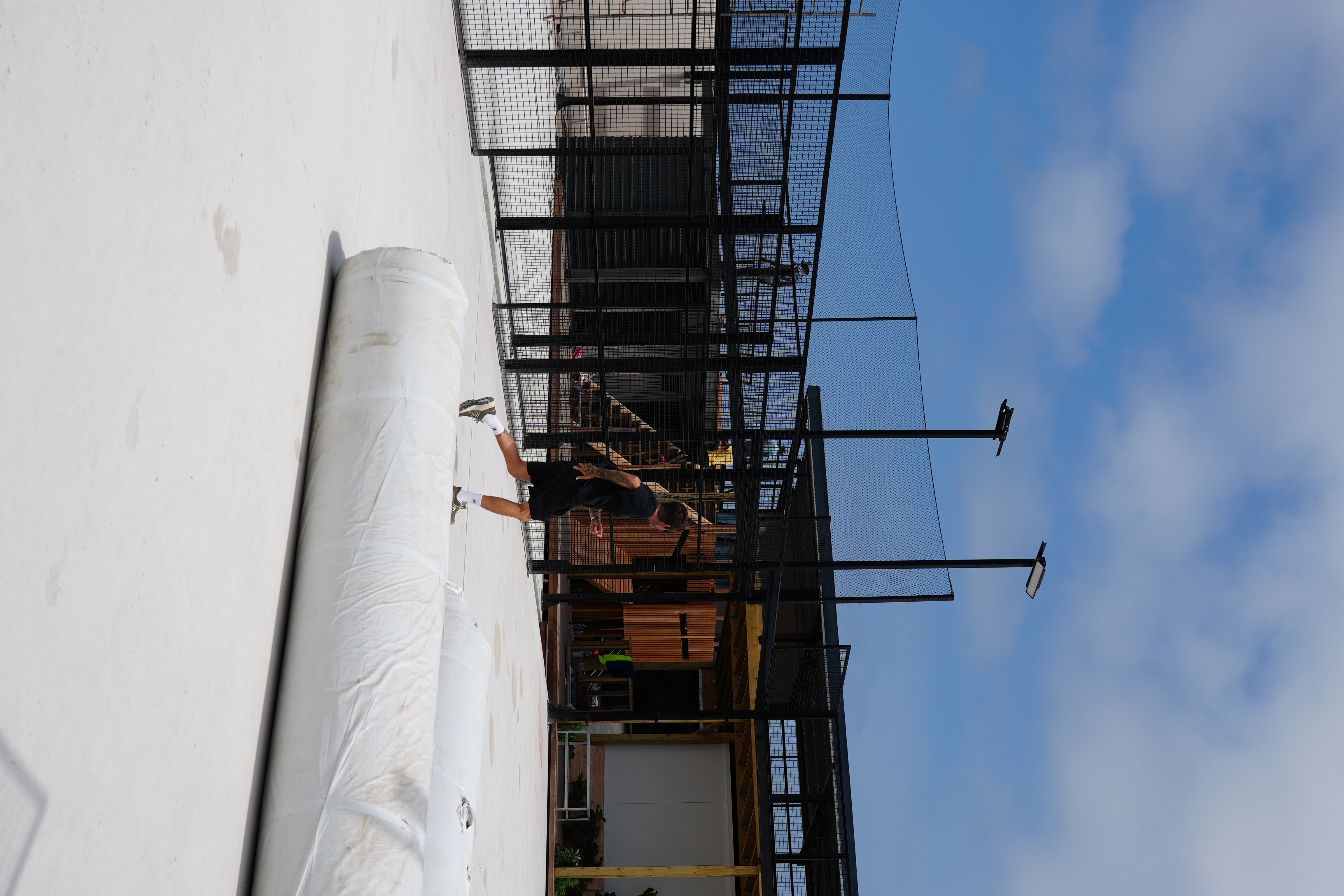 Night view of SERVE padel courts under floodlights