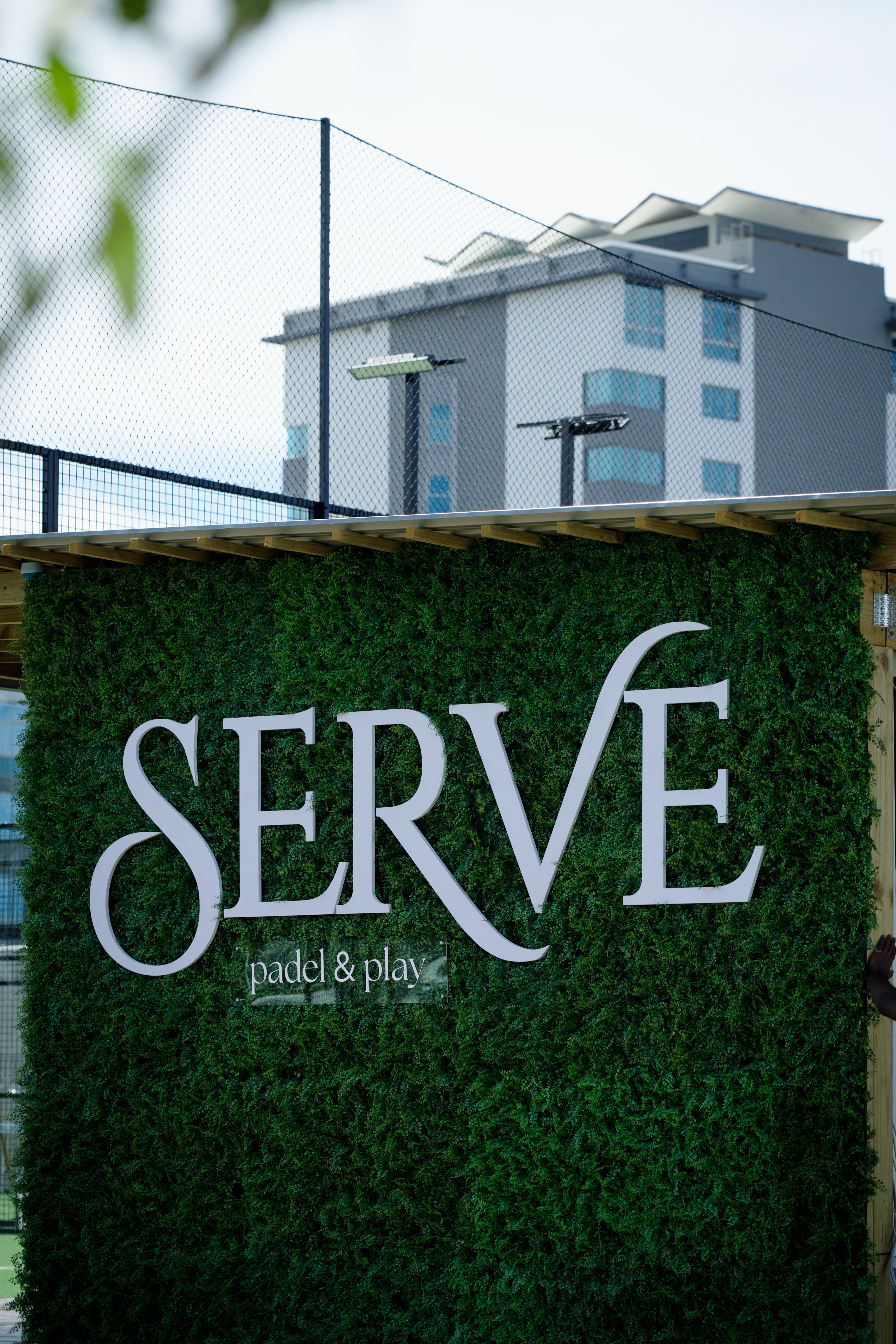 Friends celebrating after a padel match at SERVE