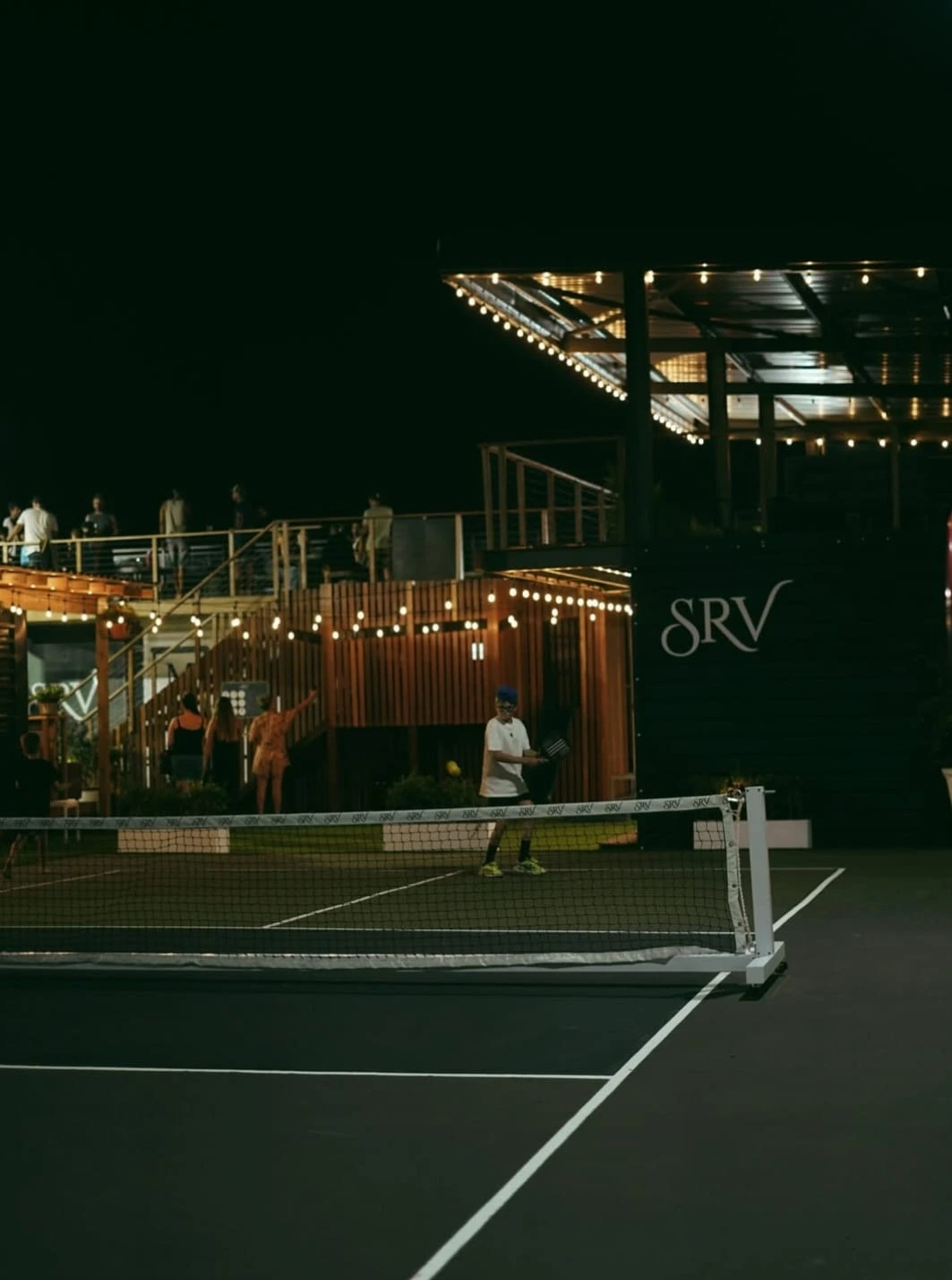 Padel court at night with SRV sign